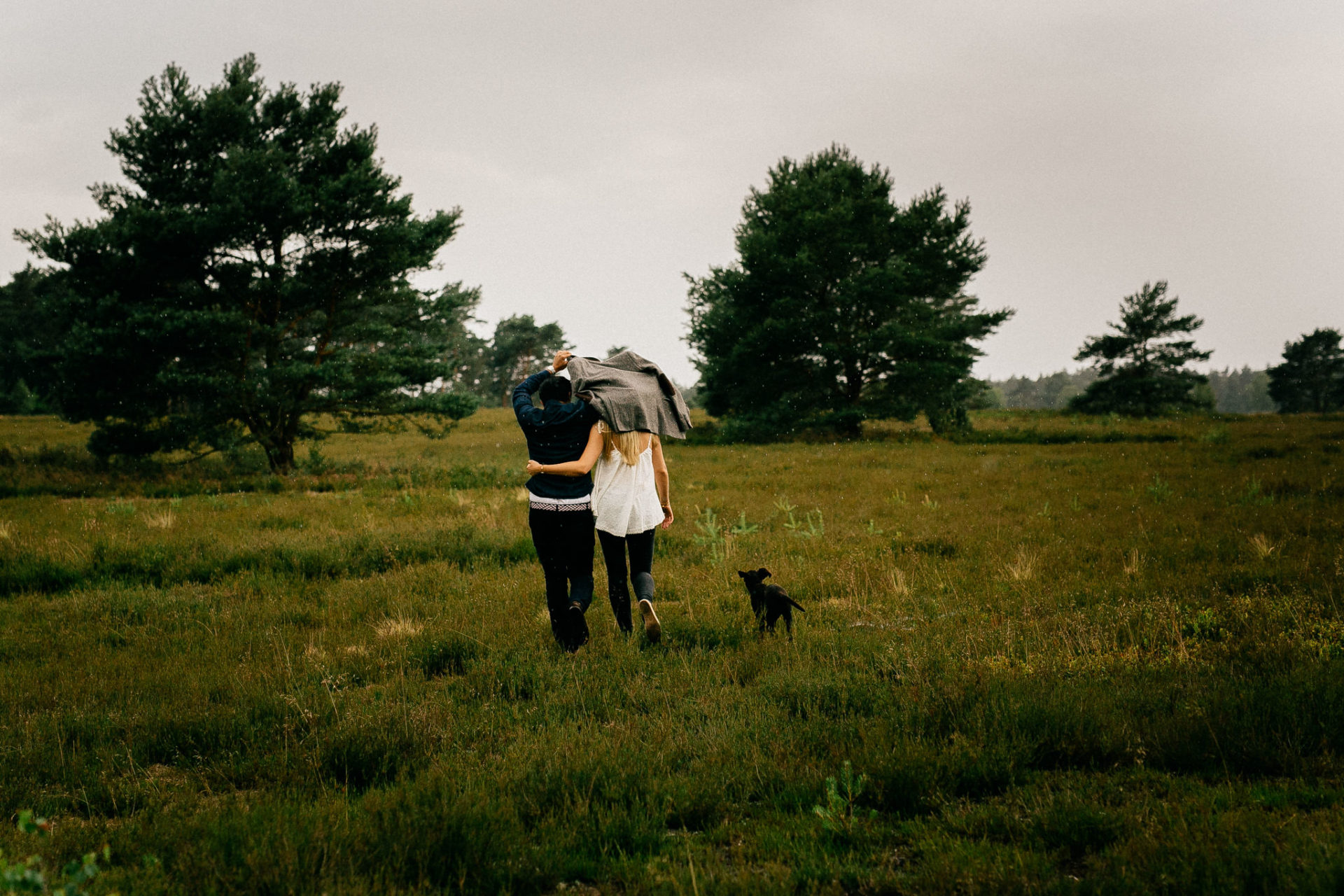 wedding photos in rain-engagement session with puppy-couple shoot dog-dogs are family-wedding photographer hamburg