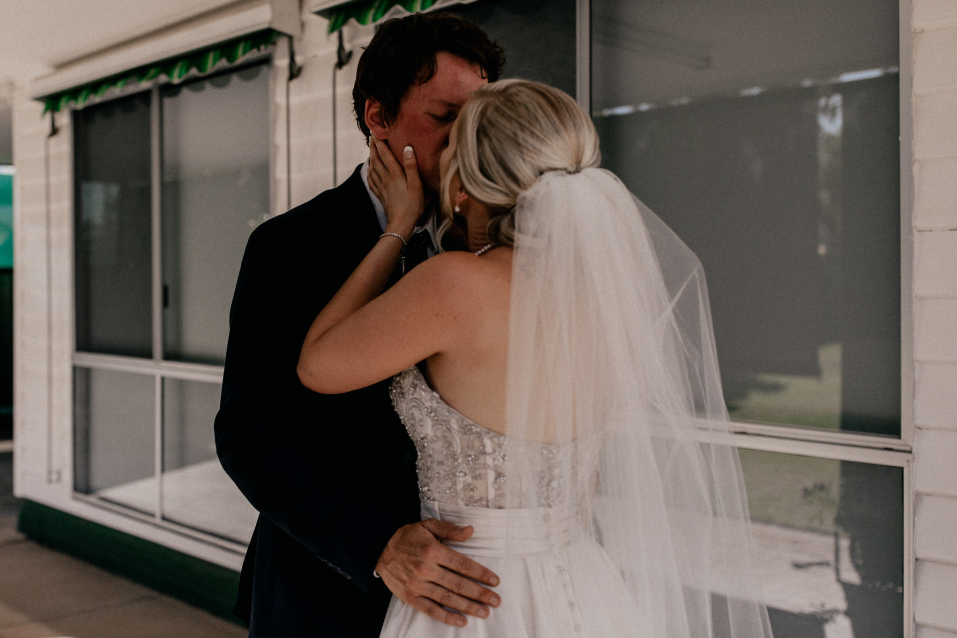 backyard-wedding-australia-melbourne-bride-groom-first-look-dancing-intimate-hug-veil-blue-suit